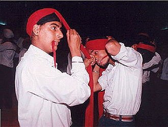 Sikh boys participate in a turban tying competition in New Delhi on Saturday