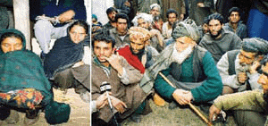 Family members of Juma Khan and Juma Ali Khan of Darriangan villlage wait after identifying the bodies which were exhumed in Chogam (Pathribal) village in Anantnag on Friday