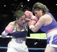 Laila Ali (left) connects against Karen Bill in the second round of a super middelewight bout at Joe Louis Arena on Saturday, in Detroit. Ali won by technical knockout in the third round 
