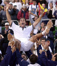Spain's Albert Costa is lifted by teammates after he beat Russia's Yevgeny Kafelnikov 6-0, 6-3, 6-0 in a Davis Cup quarter final match in Malaga on Sunday. Spain beat Russia 3-1 to qualify for the semi finals 