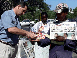  A cricket fan buys a Local Durban newspaper ahead of the first one-day International cricket match between South Africa and Australia on Wednesday