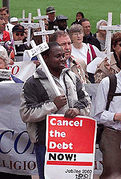 Demonstrators march from the US Capital in Washington, during a protest in favour of forgiving debt owed by developing nations on Tuesday