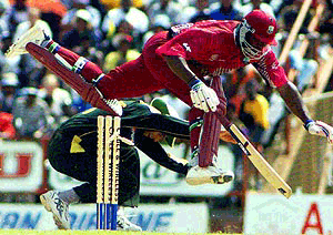 West Indies opening batsman Philo Wallace jumps overs Younis Khan of Pakistan to make it back to his creas