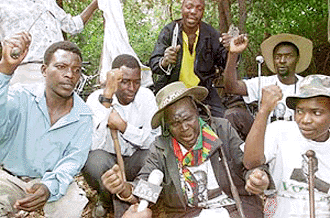 Unidentified armed war veterans occupy a white-owned farm called Bunks Hill at Harare on Thursday. Zimbabwe's Vice-President Joseph Msika asked war veterans who have invaded more than 1,000 white-owned farms in recent months to move off the farms