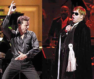 Pop singers (left) Ricky Martin, (right) Elton John perform during a concert to benefit the Rainforest Foundation in New York on Thursday