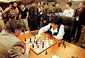 World chess champion Anatoly Karpov of Russia (left) and Xie Jun of China continue to exchange moves after their final round of the Chess King and Queen Competition held in Guangzhou, the capital city of south Chinas Guangdong Province, on Tuesday. The match ended in a draw.  AP/PTI