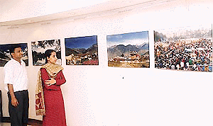 Visitors at an exhibition of photographs at Indus Ind Bank Art Gallery in Chandigarh on Saturday