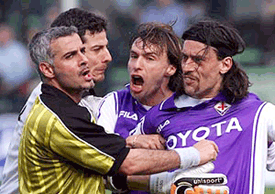 Referee Daniele Tombolini (left) foreground, argues with Fiorentina's goalie Francesco Toldo (left background) and defenders Enrico Chiesa (centre) and Moreno Torricelli (right) after awarding a penalty kick, during the Italian first division Serie A match Fiorentina vs Lazio of Rome, at the Florence Franchi stadium