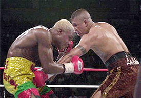 Fernando Vargas, right, lands a low blow to Ike Quartey during the ninth round of their IBF junior middleweight championship fight at Mandalay Bay in Las Vegas on Saturday. Vargas won the 12-round fight in a unanimous decision
