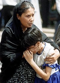 A Shia Muslim woman comforts her daughter who broke down during a demonstration by Shia Muslims on the occasion of the 10th Moharram in New Delhi on Sunday. The demonstrators were protesting against the massacre of Shia Muslims in Pakistan while they were participating in a religious congregation to mark the Muslim holy month of Moharram