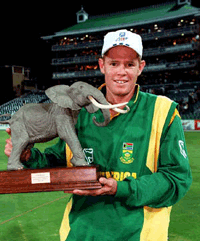 South African cricket captain Shaun Pollock holds the winners trophy after South Africa won the final match and the One Day International series against Australia 2-1 at the Wanderers Cricket Stadium