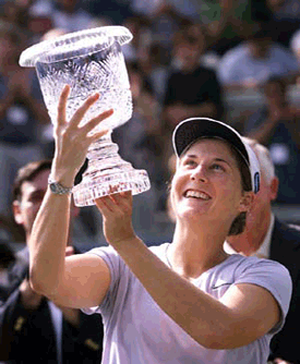 Monica Seles admires the trophy after successfully defending her Bausch & Lomb Championship on Sunday