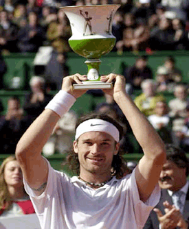 Spain's Carlos Moya lifts his trophy after winning the Estoril Tennis Open in Oeiras, outside Lisbon on Sunday