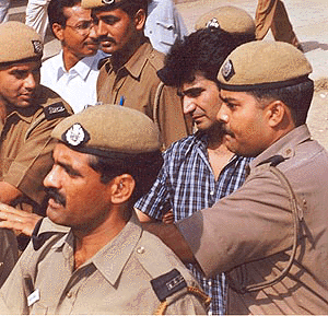 Bollywood actor Kishan Kumar, brother of slain music baron Gulshan Kumar, is taken to the Patiala House courts in New Delhi on Thursday under police escort in connection with the ongoing cricket match-fixing case