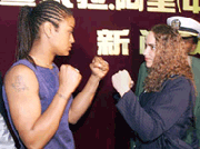 Laila Ali (L), daugther of former world heavyweight champion Muhammad Ali, faces off with Kristina King, known as "the world's toughest woman," 21 April 2000 at a press conference in Guangzhou