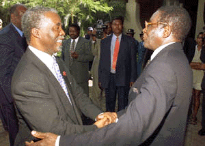 Zimbabwean President Robert Mugabe (right) greets his South African counterpart, Mr Thabo Mbeki, on his arrival at the Elephant Hills Hotel in Victoria Falls for a summit on Friday