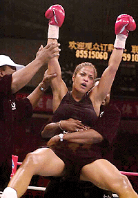  GUANGZHOU, CHINA : Laila Ali from Miami Beach, raises her arms in victory as she defeats Kristina King, from Muskegon, at Tian He stadium in the southern Chinese city of Guangzhou on Saturday. Ali won by technical knockout in the fourth round of the first major boxing event since the founding of the People's Republic of China. AP/PTI