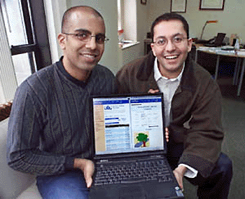 Raj Yersai (left) and Sumit Kapur, young Indian businessmen who founded a web auction site to sell American products back home, show off the home page of their site, left side of screen, and a piece of artwork up for auction, on the right in their New York office. Keeping one foot in the USA and the other in India is allowing a trickle of entrepreneurs to take advantage of the growing connections between the two countries technology industries.  AP