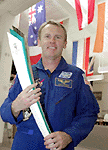 Australian born astronaut Andy Thomas holds the Olympic torch during a visit to the Kennedy Space Centre on Monday at Florida