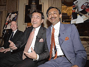 The New York Islanders' new owners, software executives Charles Wang, centre, and Sanjay Kumar, right, share a laugh at Garden City, New York,