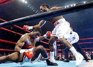Michael Grant (left) of Norristown, Pa., goes down for the second time during the first round as Lennox Lewis