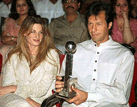 Former Pakistani cricketer Imran Khan, along with his wife Jemima Khan, holds the Award for Sportsman of the Millinium trophy in the Pakistan Television awards ceremony in Lahore on Saturday evening