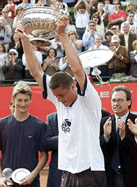Russia's Marat Safin, looks at the ground after the bottom of the trophy he is lifting fell off, following his triumph over Spain's Juan Carlos Ferrero in the Conde de Godo Tennis Open