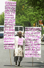 A lone protester displays placards denouncing politicians as corrupt and inept during a lone May Day protest near parliament, 01 May 2000. The demonstrator also denounced the dowry system, called for prohibition in India and suggested to send all politicians to a penal colony