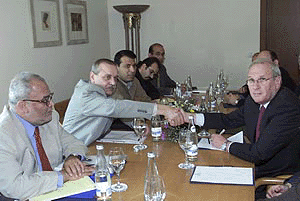 Palestinian chief negotiator Yasser Abed Rabbo ( second from left ) and his Israeli counterpart, Oded Eran (right), shake hands as the Palestinian chief negotiator for the interim talks, Saeb Erakat (left), and Mohammad Dahlan , head of Palestinian internal security in the Gaza Strip, look on at the start of the third round of negotiations between Israelis and Palestinians at Eilat on Sunday