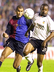 F.C. Barceona's Brazilian forward Rivaldo (left) tries to get to the ball ahead of F.C. Valencia's Jocelyn Angloma of France