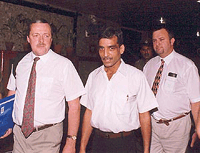 A Delhi Police official (centre) escorts Inspector Martin Hawkins and Sargent Abbroi from Scotland Yard at the Police Headquarters in New Delhi on Wednesday
