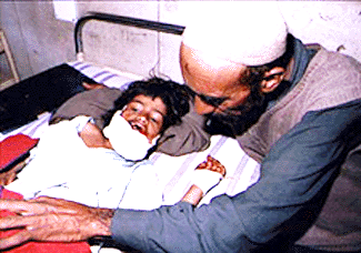 A six-year-old girl being looked after by her father in a Srinagar hospital on Thursday. The girl is among 12 school children seriously injured in the Pakistan shelling in the Uri Sector on Wednesday