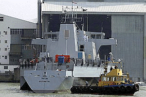 The RV Triton is assisted by a tugboat, right, at Southampton, southern England, after its launch from the Vosper Thorneycroft yard in the suberb of Woolston, Southampton, on Saturday. The 13 million pound ($20 million) triple-hull vessel is due to begin sea trials for the Defence Evaluation and Research Agency (DERA) later this year and could eventually replace the Royal Navy's Type 22 and 23 frigates. 