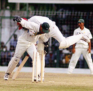 Curtly Ambrose of the West Indies, right, collides into Pakistan captian and wicketkeeper Moin Khan, on a successful return to his crease, during the third day of the first test match at Bourda cricket ground in Georgetown, Guyana Sunday