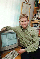 Nineteen-year-old Swedish student Jonathan James, who helped the FBI to find the creators behind the "ILOVEYOU" virus, poses along side his computer at his home in Holmskog,  150 km north-west of Stockholm, Sweden, on Tuesday . Earlier, he helped the FBI  track down the makers of the virus "Melissa". 