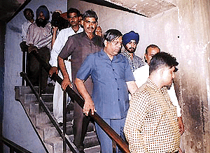 UT Home Secretary N.K. Jain, who is facing corruption charges, being brought out of the court of Chief Judicial Magistrate on Wednesday.	