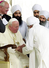 Pope John Paul II receives a delegation of unidentified Indian Sikhs in St. Peter's square during the weekly general audience at the Vatican, Wednesday. On Friday the pontiff begins a two-day visit to a shrine in Fatima, Portugal, to beatify two peasants who as children reported witnessing apparitions of the Virgin Mary in 1917