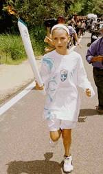 Sophie Gosper, the daughter of Australian International Olympic Committee vice-president Kevan Gosper, runs with the Sydney torch after the official Olympic flame lighting ceremony in Ancient Olympia on Wednesday.
