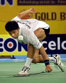 Malaysia's Wong Choong Hann returns the shuttlecock to South Korean Shon Seung Mo 