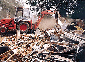 A bulldozer demolishes illegal structures in the Sector 31 Labour Colony of Chandigarh on Friday