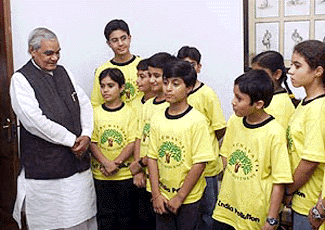 Prime Minister Atal Bihari Vajpayee with the children of Panchwati Green Movement at his residence in New Delhi on Friday