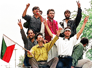 Senior Jammu and Kashmir Libration Front leader Javed Ahmad Mir (C-red vest) stands on top of a vehicle in the Kashmiri capital of Srinagar 13 May 2000. Hundreds of supporters received Javed Mir at Srinagar airport after he was released from six months long detention