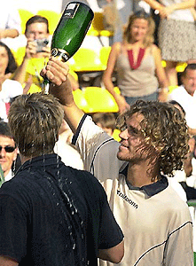Brazil's Gustavo Kuerten (right) spills champagne on Magnus Norman of Sweden after being defeated in their men's Italian Open tennis final at Rome's Foro Italico on Sunday. Norman beat Kuerten 6-3, 4-6, 6-4, 6-4. 