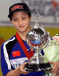 China's world No 2 Gong Zhichao displays the Uber Cup during the award ceremony at the Putra Stadium in Kuala Lumpur on Saturday. Chinese women beat Denmark 3-0 and retained the Uber Cup