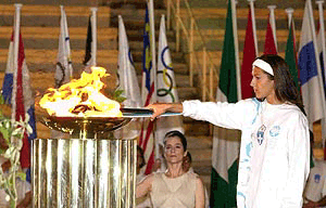 Greek triple jump world champion Voula Tsiamita, the last bearer of the Olympic flame on Greek soil, lights a special urn during the handing over ceremony of the flame to the Australian organizers at the Pan Athenian stadium, site of the first modern Olympics in 1896, on Saturday