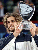 Brazilian tennis player Gustavo Kuerten displays the trophy after his match against Russia's Marat Safin in the final of the ATP tennis tournament in Hamburg, northern Germany on Sunday