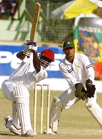 West Indies batsman Wavell Hinds hits his final four to complete his half century during the fifth day of the second test match at the Kensinhigton Oval in Bridgetown, Barbados on Monday
