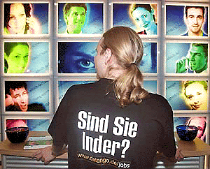 A young headhunter from an internet job market waits for interested people at the "Internet World 2000" fair in Berlin Tuesday. The slogan on his shirt reads "Are you an Indian ?", that relates to the current campaign of the German government to hand out so-called green cards to thousands of Indian computer experts to work in Germany, because this German industrial sector has an immense manpower shortage. The fair will be opened until May 25