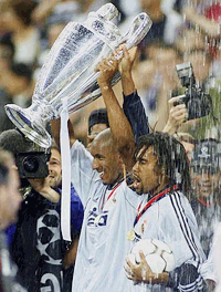 Real Madrid's Frnch players Nicolas Anelka, left, and Christian Karembeu hold the trophy after they beat Valencia 3-0 during their UEFA Champions' League final soccer match at the Stade de France in Saint-Denis, north of Paris on Wednesday