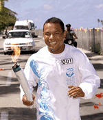 Nauru's "golden boy" weightlifter Marcus Stephen beams as he became the first torchbearer to run with the Olympic torch in Nauru, a tiny island floating in the western Pacific, on Thursday